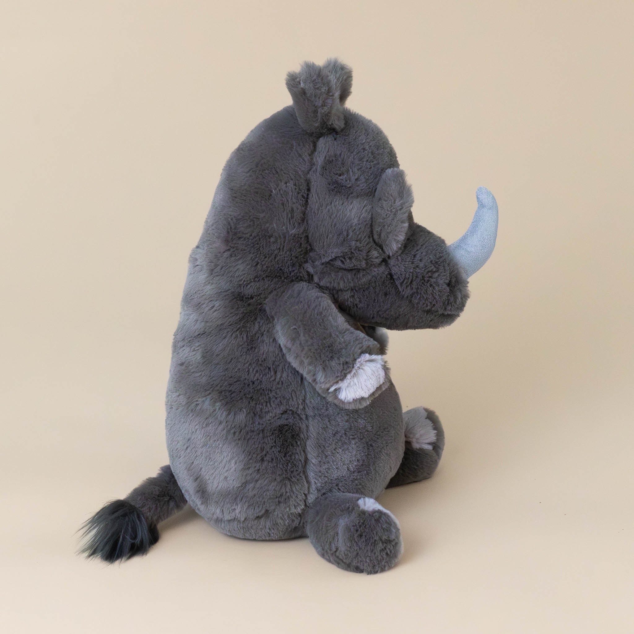 roderick-rhinoceros-grey-stuffed-animial-with-light-grey-horn-hooves-and-fluffy-tail-side