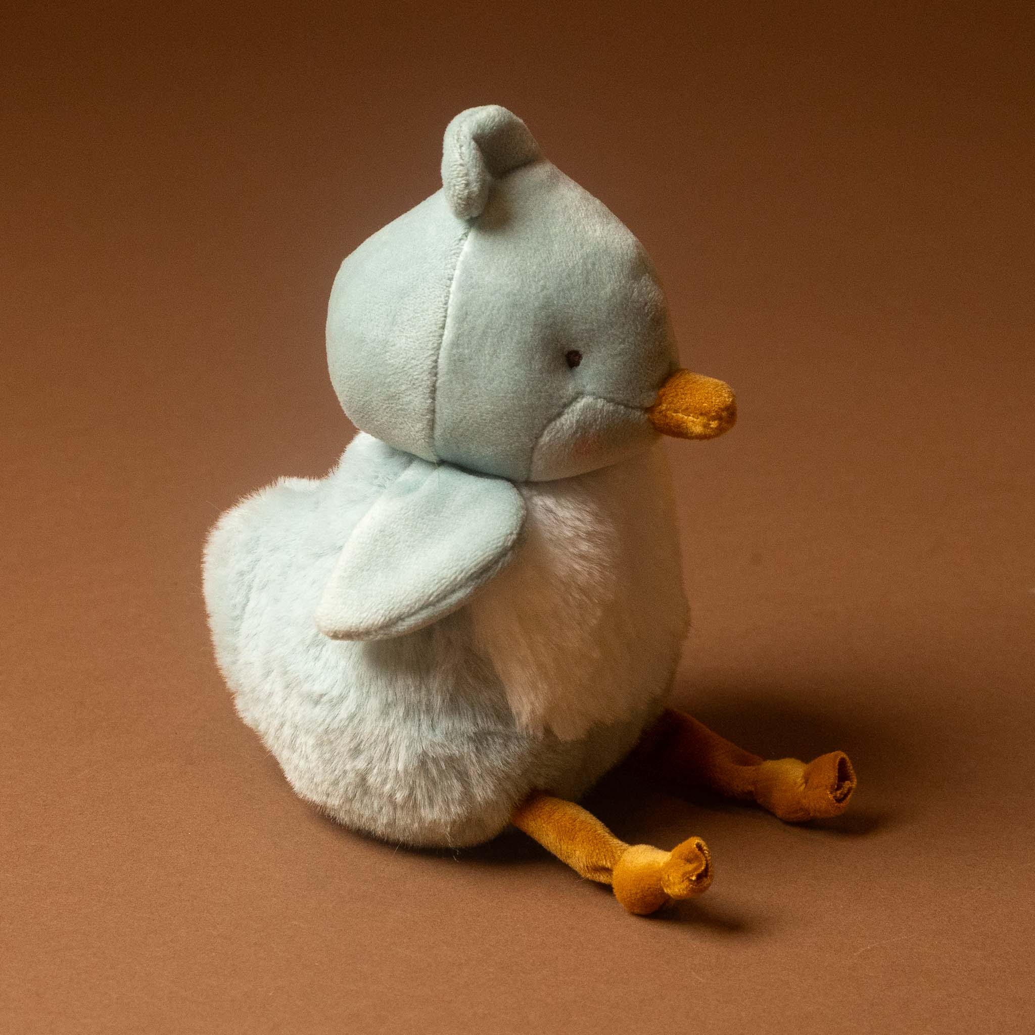A plush roly-poly-birdie-tweet with pale blue feathers, a white belly, and orange beak and legs