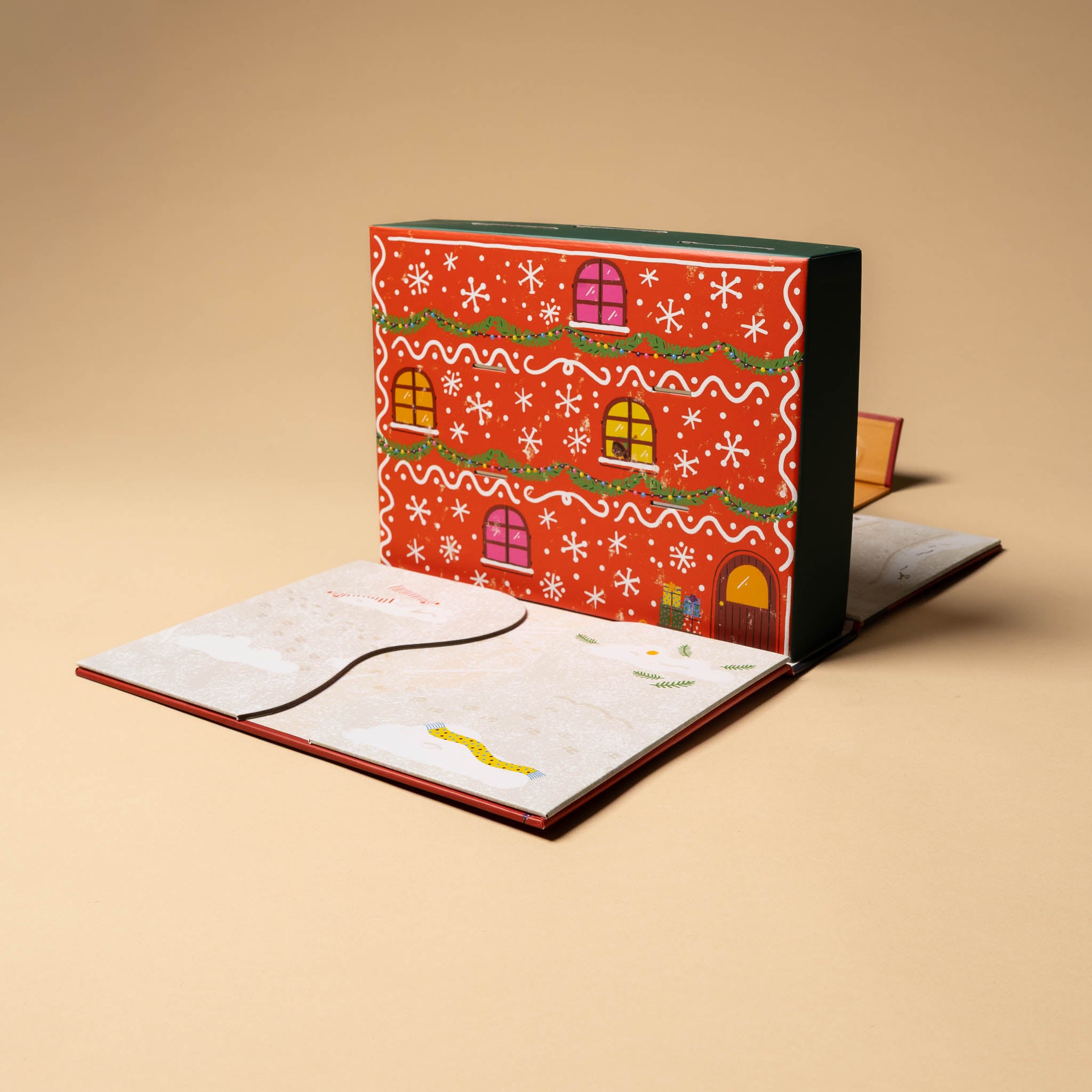 santas-workshop-a-pop-and-play-activity-kit with gingerbread house design on a beige background