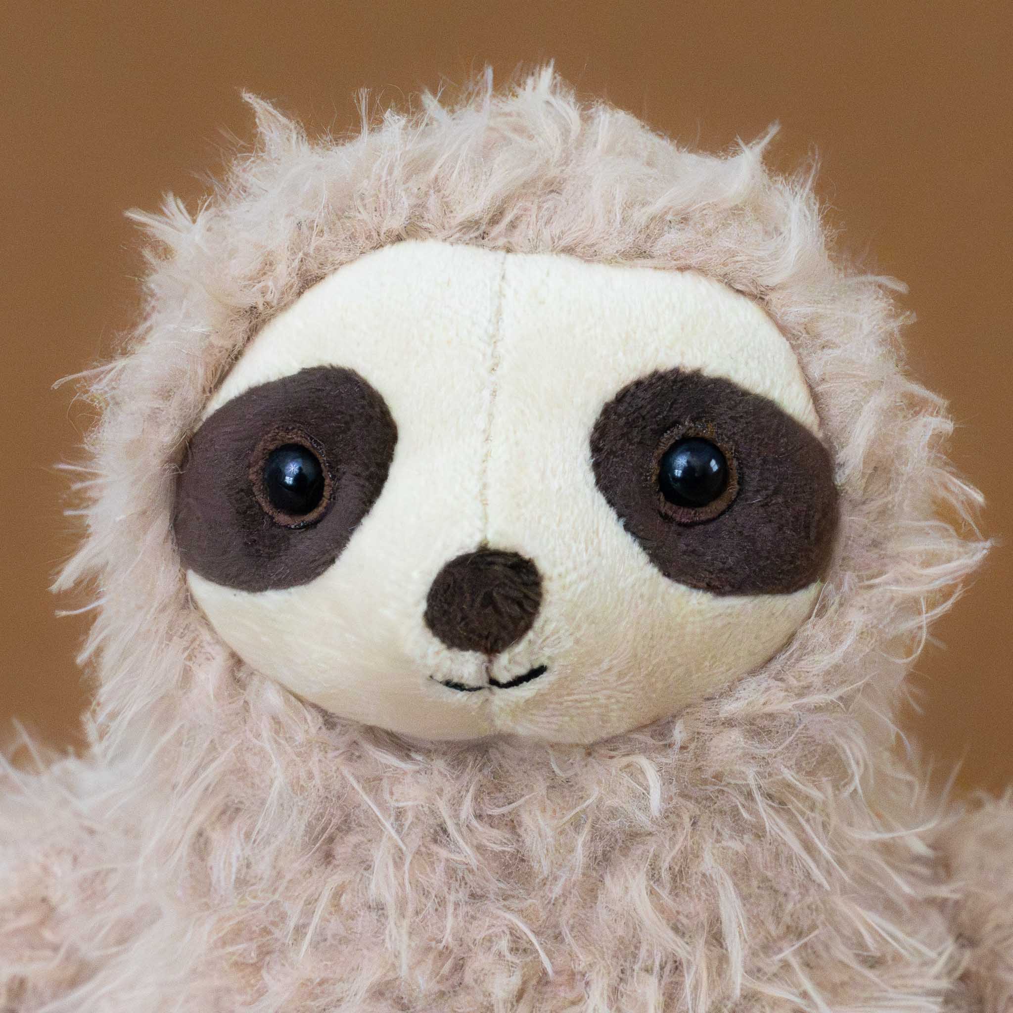 selma-sloth-tan-stuffed-animal-with-long-arms-and-legs-face