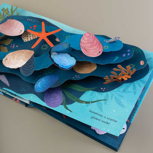 interior-page-with-pop-up-layers-of-watter-with-shells-starfish-and-coral