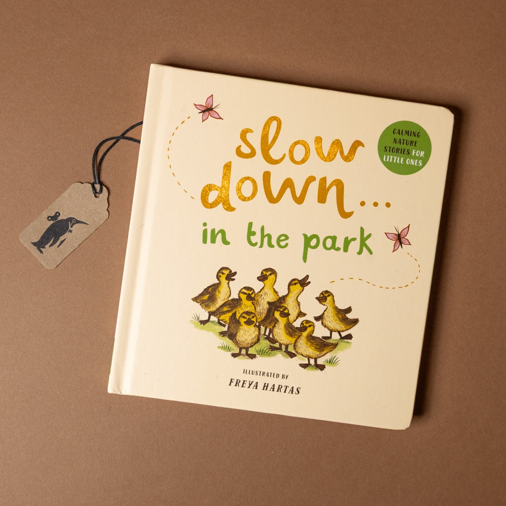 slow-down-in-the-park-board-book Book titled 'slow down... in the park' with illustrations of ducklings on a brown background