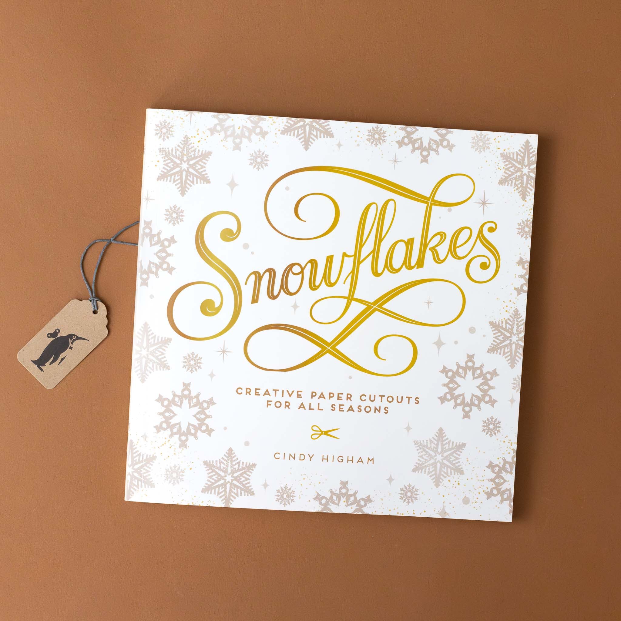 snowflakes-creative-paper-cutouts-for-all-seasons-white-cover-book-with-gold-foil-title-and-grey-example-snowflakes