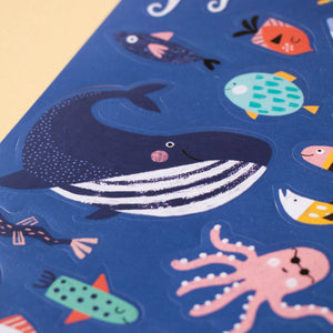 sticker-activity-book-under-the-sea-cover-with-a-whale-two-snorklers-fish-coral-under-the-sea-whale