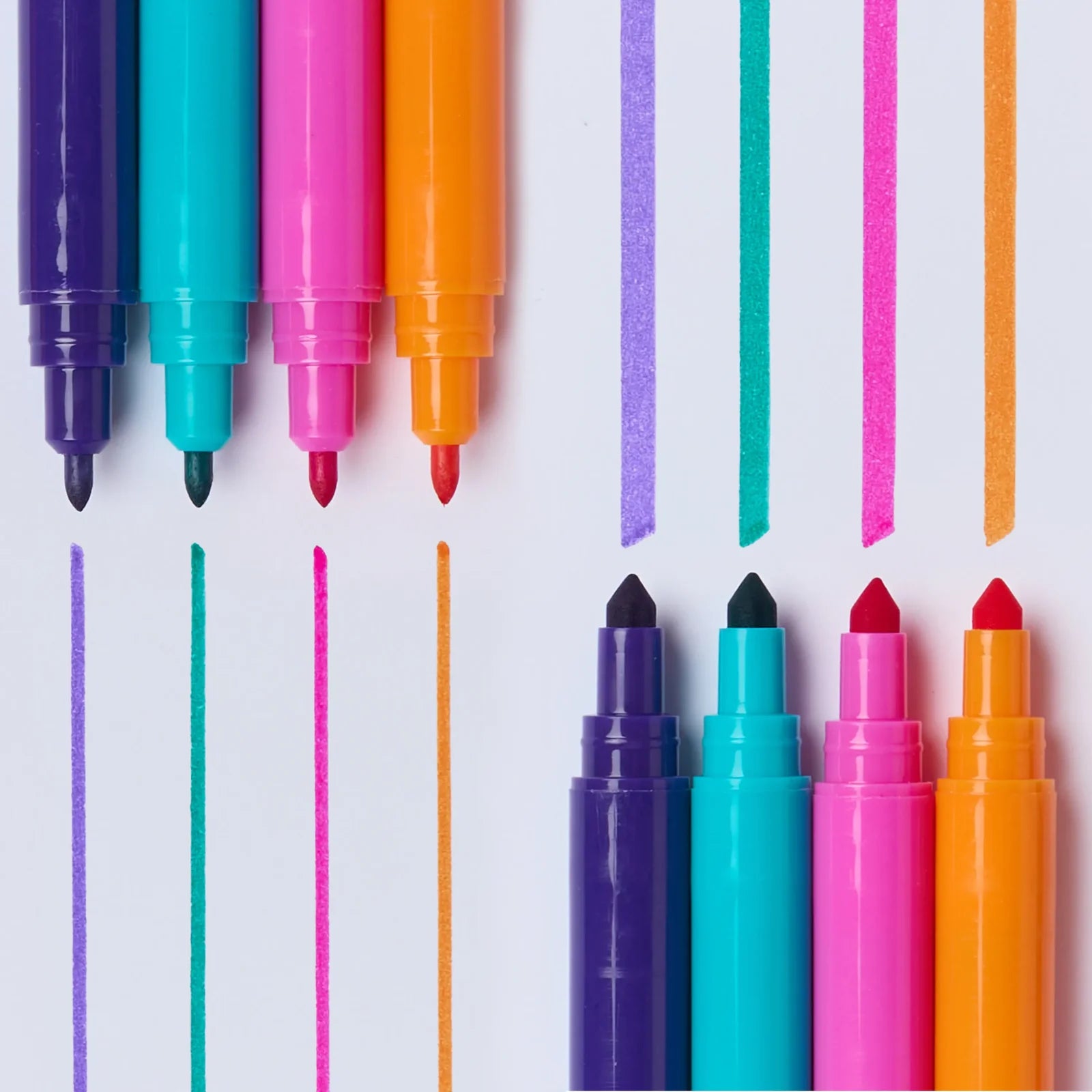 Five colorful dual-tip markers in purple, teal, pink, orange, and red are arranged on a white background, with vertical colored lines extending from the tips above and below them.