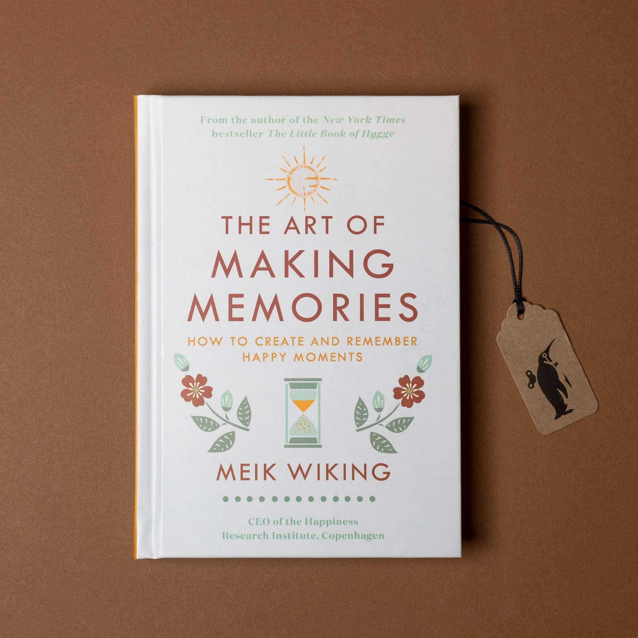 Book titled 'The Art of Making Memories' by Meik Wiking on a brown background