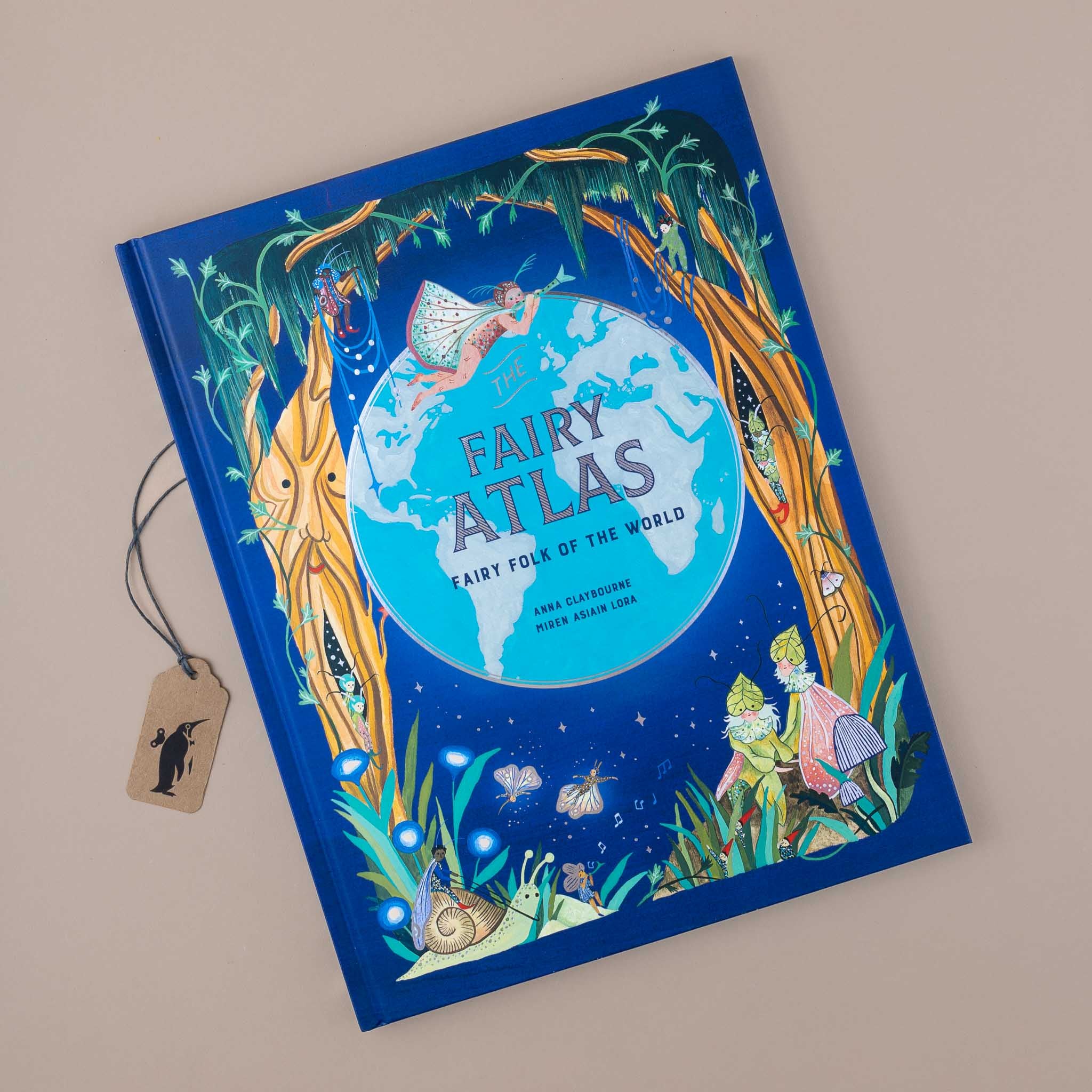  the-fairy-atlas-book-blue-cover-with-globe-in-the-center-surrounded-by-fairies