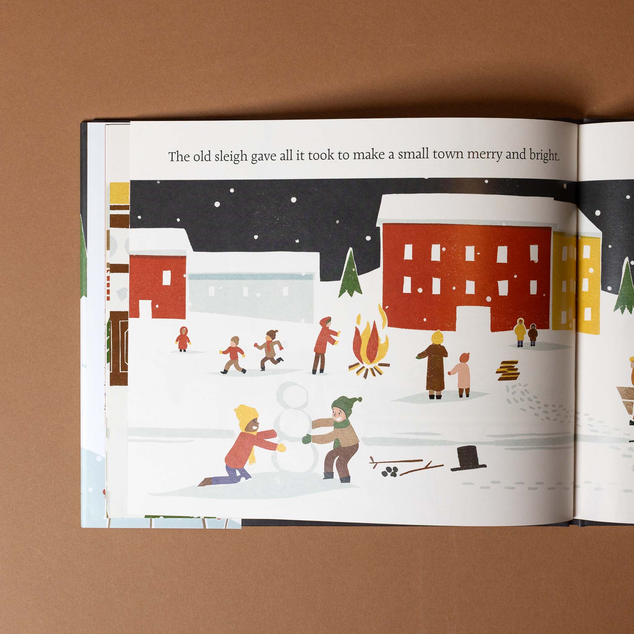 the-old-sleigh Illustrated book page showing a winter scene with people around a fire and snowball fight.