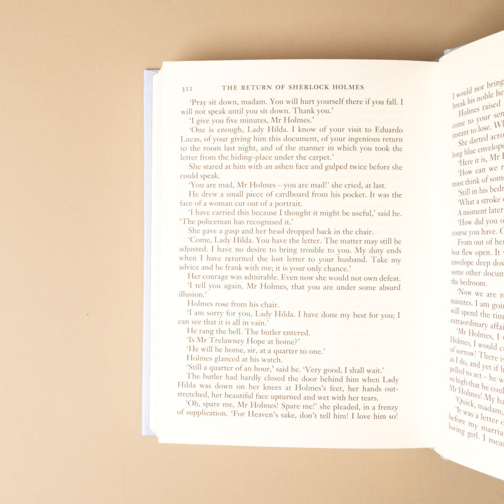 the-return-of-sherlock-holmes Open book with text on a beige background