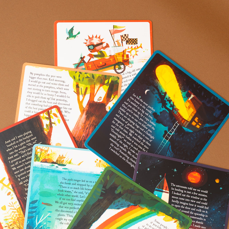 A fan-like arrangement of colorful illustrated cards with printed text and whimsical artwork, photographed on a warm tan background.