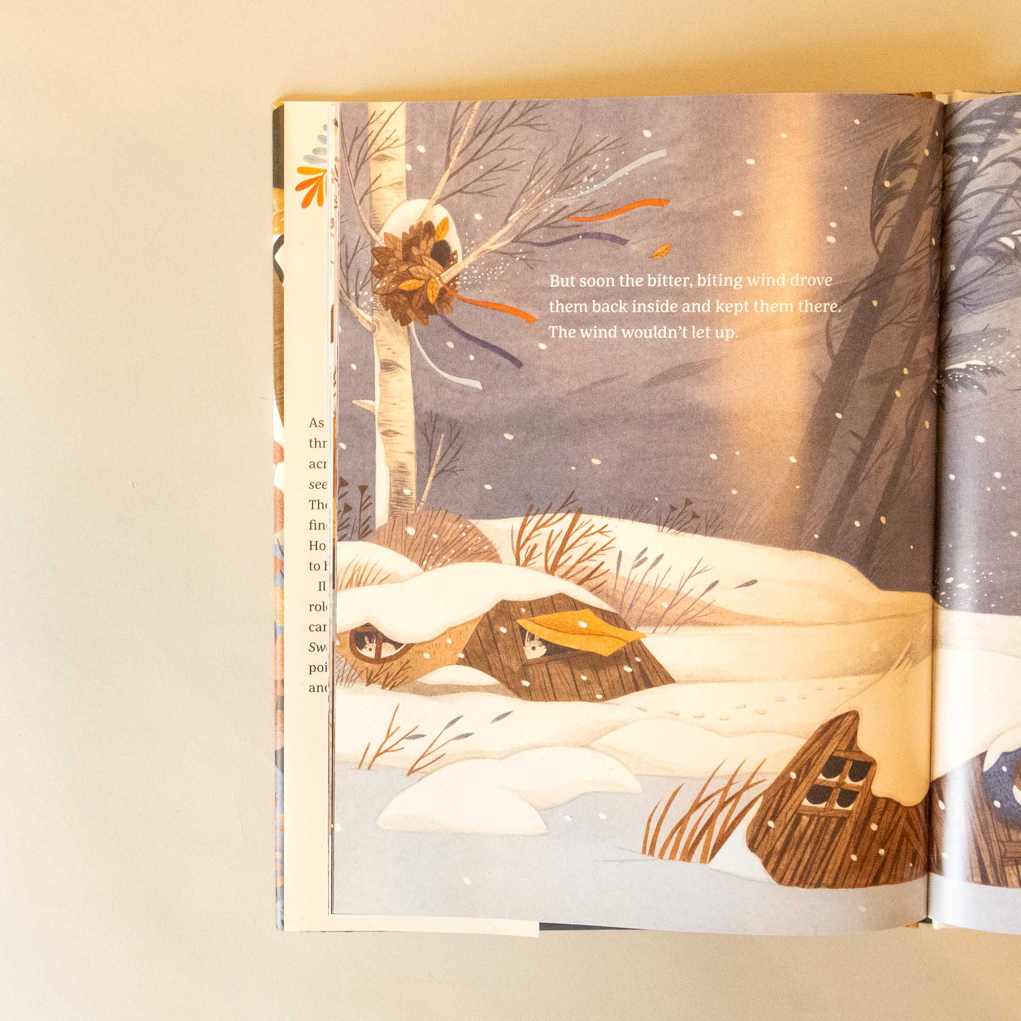 Illustrated the-sweater-a-story-of-community open to a page with winter scene and text