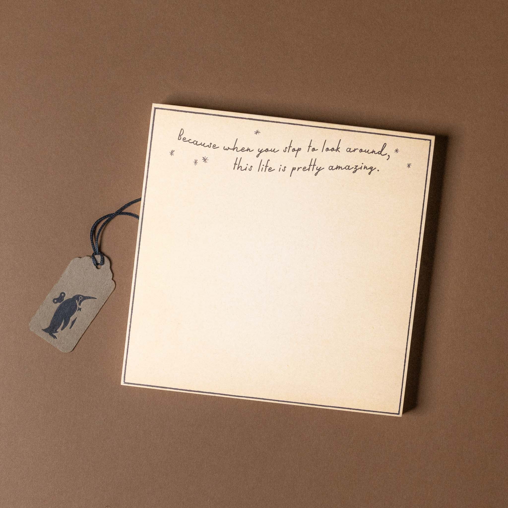 Notebook with a quote and a tag on a brown background