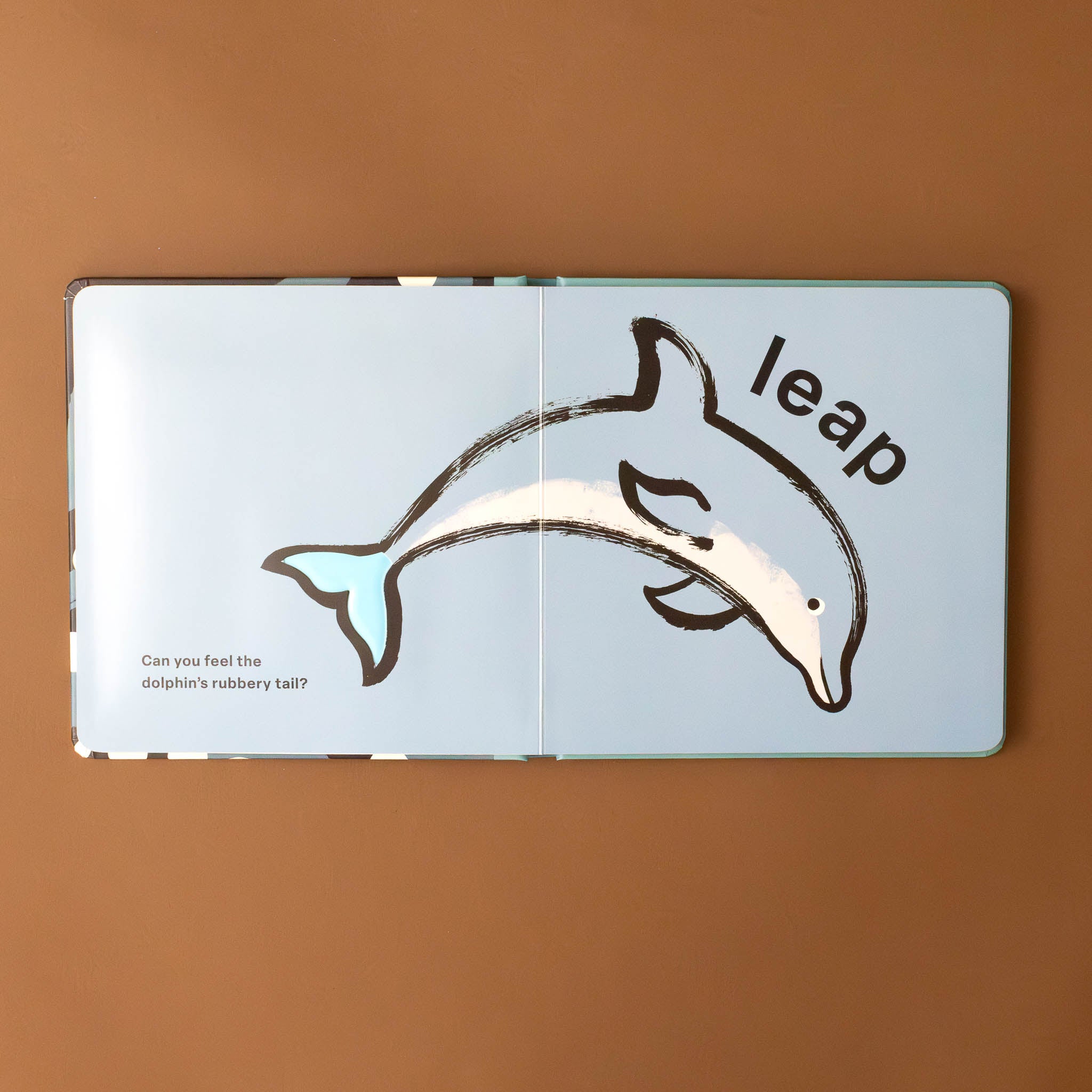 dolphin-with-the-word-leap-above-and-text-can-you-feel-the-dolphin's-rubbery-tail?