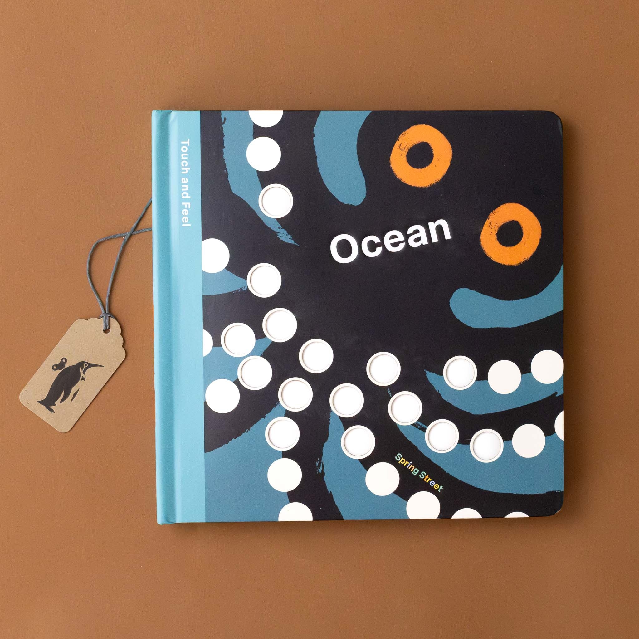 touch-and-feel-board-book-ocean-cover-with-orange-eyed-black-octopus-with-circular-bumps-in-blue-sea