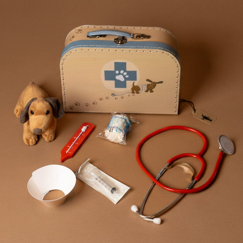 veterinary-case Children's toy medical kit with stethoscope, syringe, and plush dog on a brown background