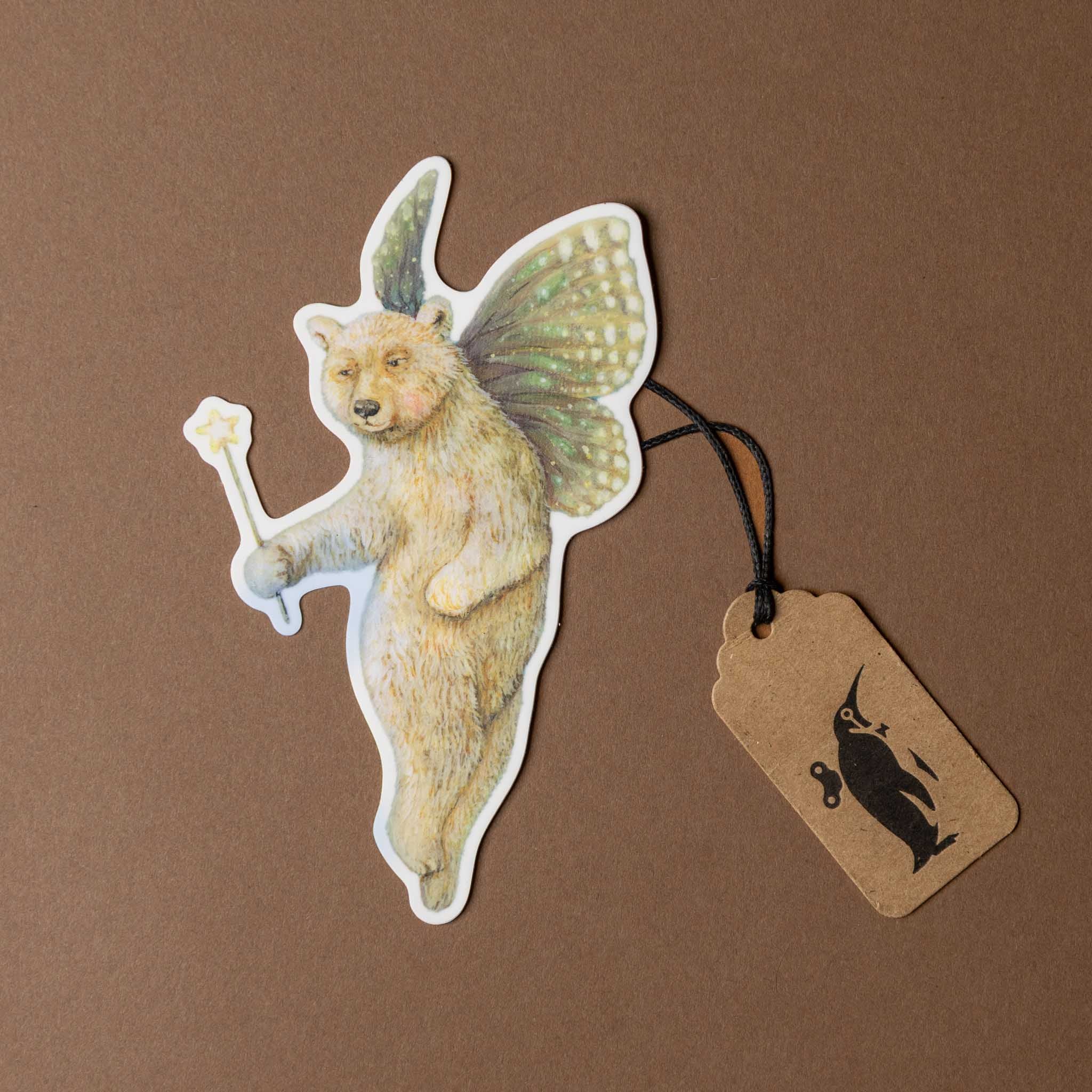 vinyl-die-cut-sticker-faerie-bear Sticker of a bear with fairy wings on a brown background