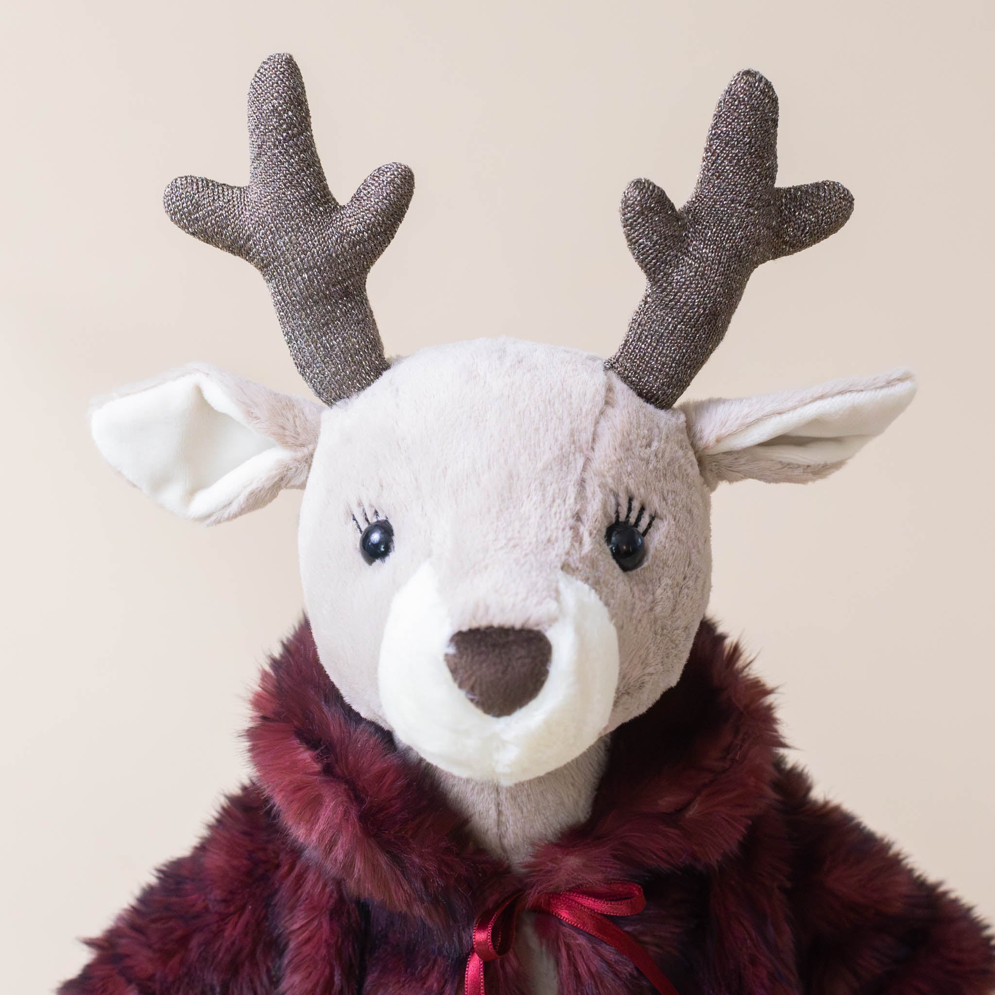 vivian-reindeer-face-with-eyelashes-stuffed-animal-with-fur-coat-tied-with-red-bow