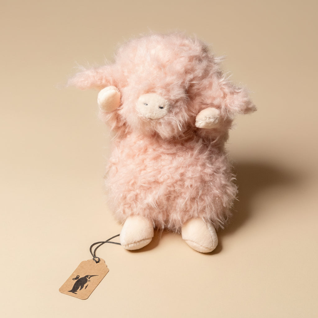 wee-piggy-hammie Pink plush toy sheep with a tag on a beige background