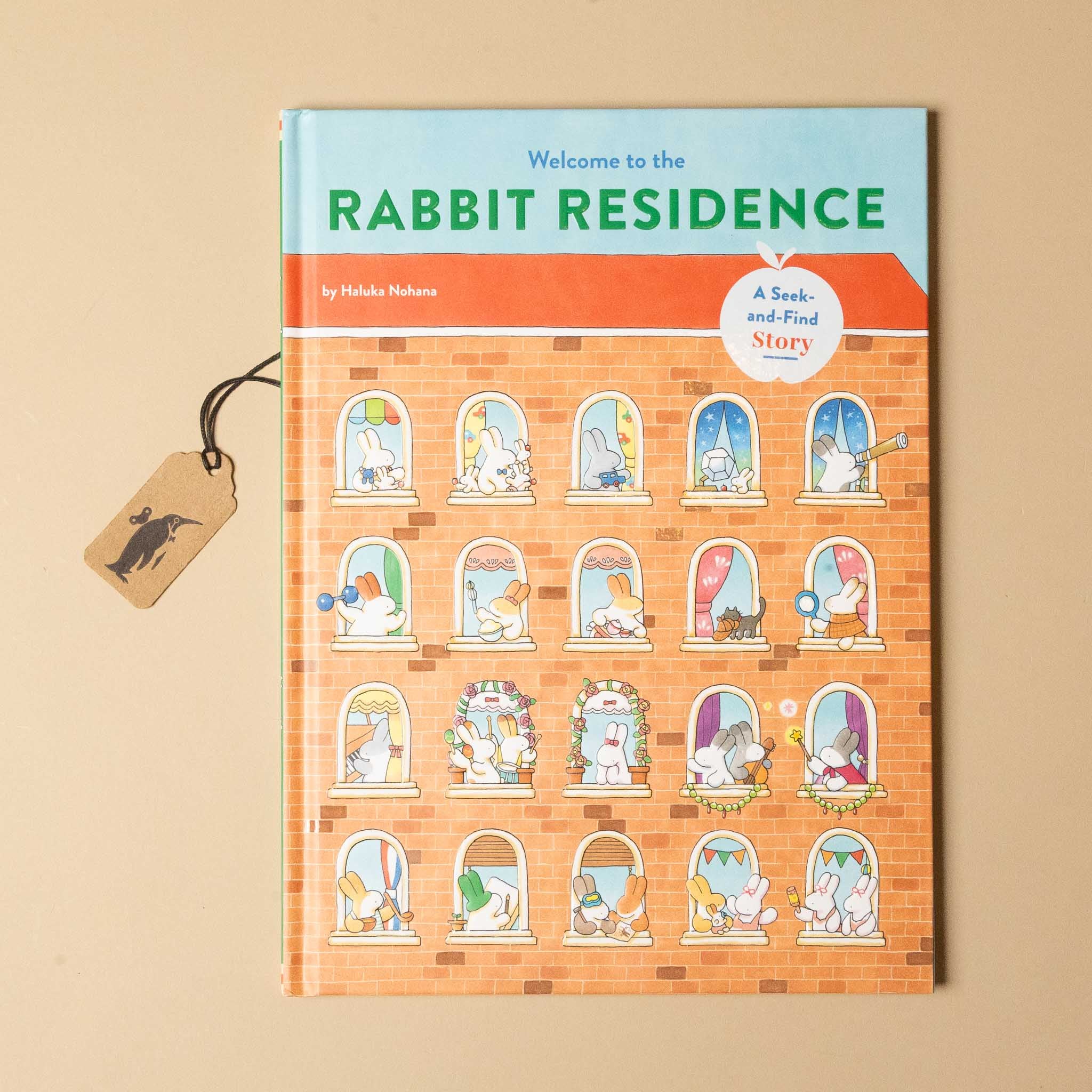 Children's book titled 'Welcome to the Rabbit Residence' on a beige background