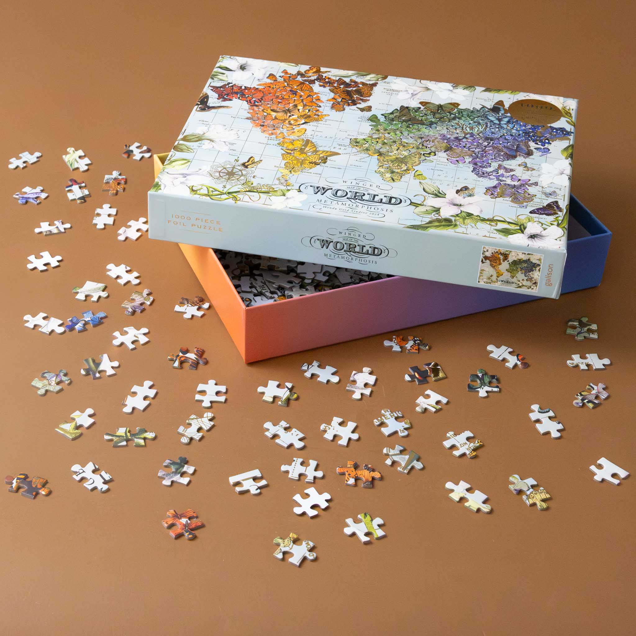 wendy-gold-winged-metamorphosis-1000-piece-gold-foil-puzzle-of-butterfiles-on-a-map-of-the-world-example-pieces