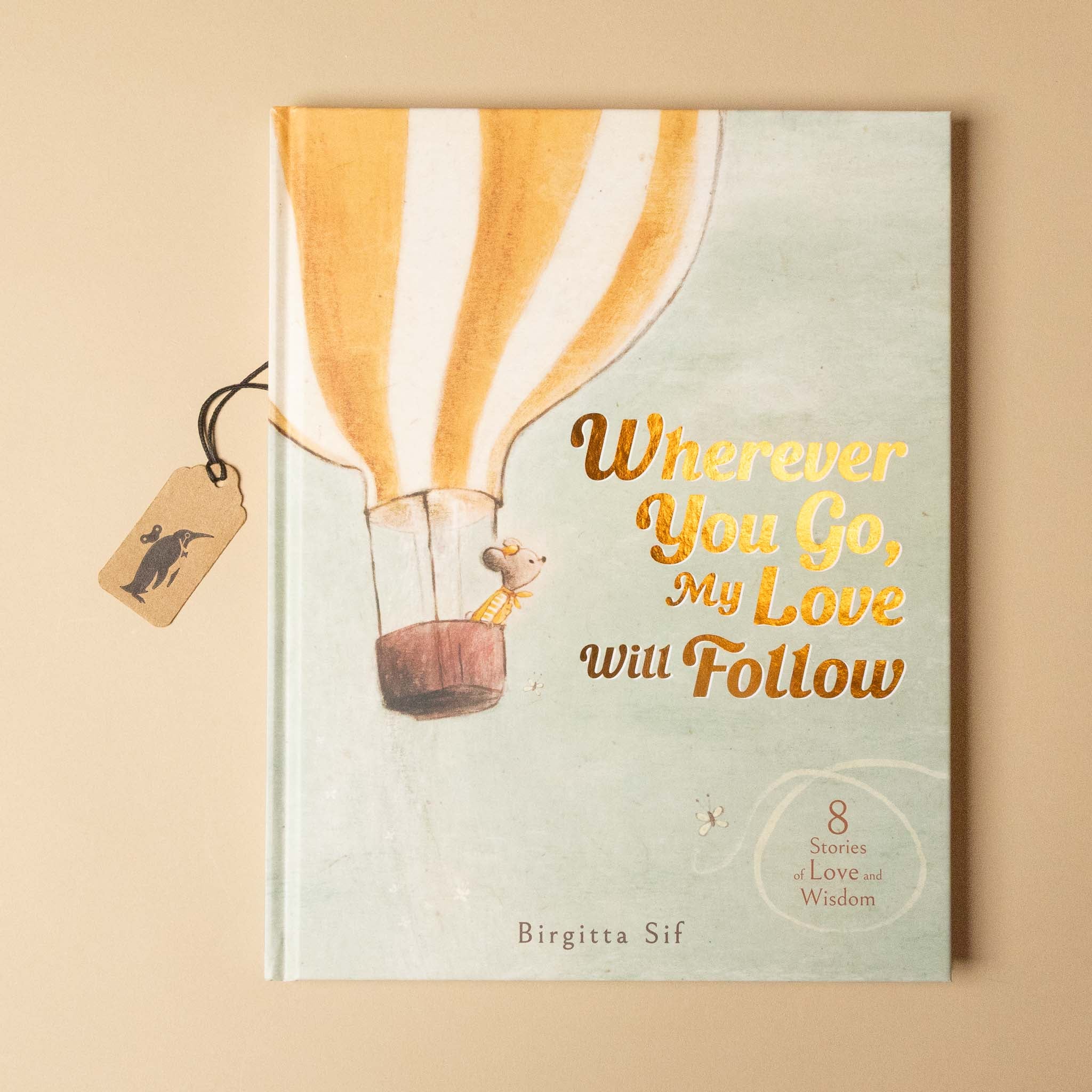 Book titled 'Wherever You Go, My Love Will Follow' with a hot air balloon illustration on a beige background.