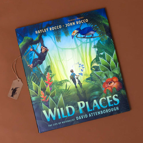  Analyzing image     wild-places-the-life-of-naturalist-david-attenborough-cover-with-a-young-boy-walking-his-bicycle-thru-a-jungle-with-bird-of-paridise-toucans-and-monkey-around