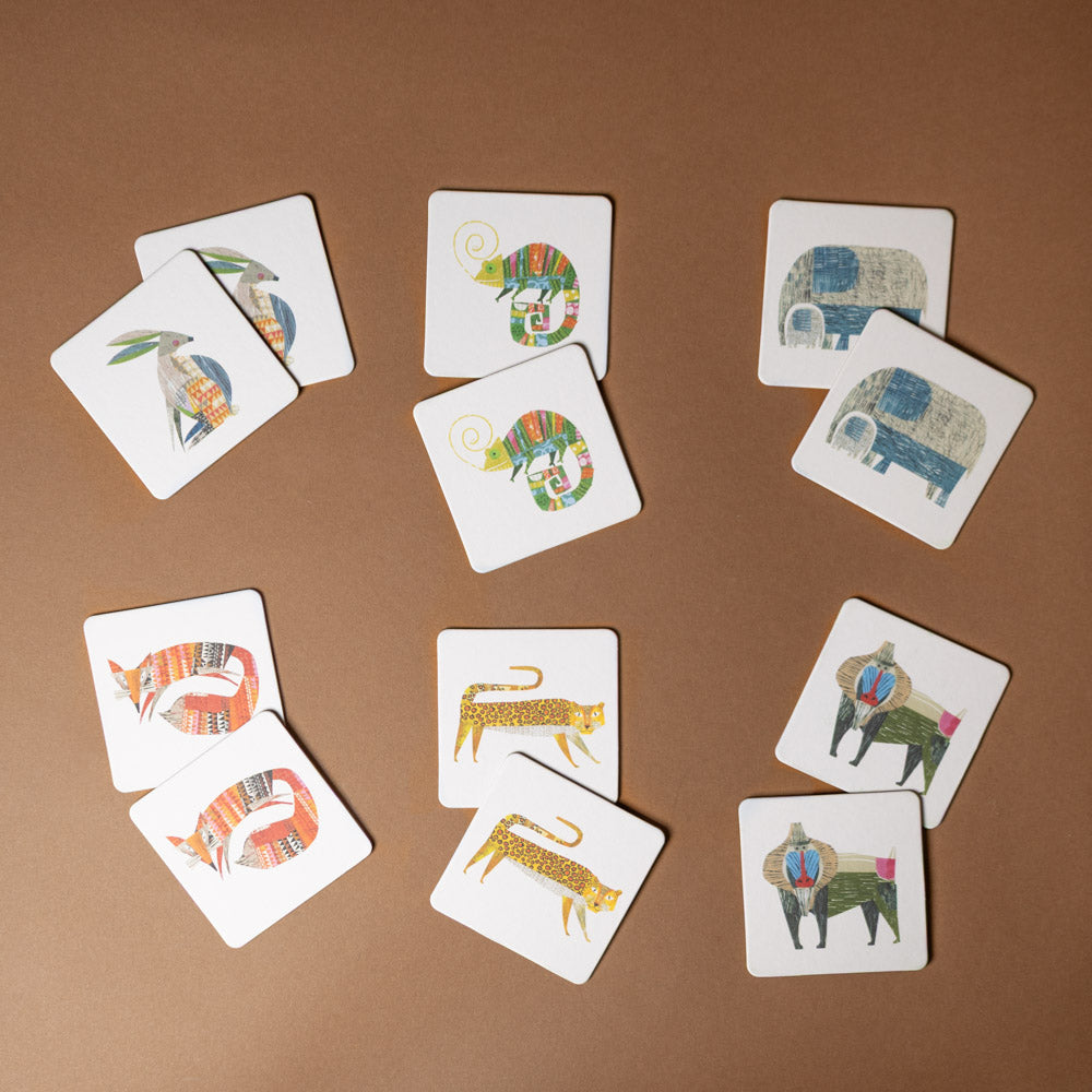 wildlife-collage-memory-game Set of animal-themed playing cards on a brown background