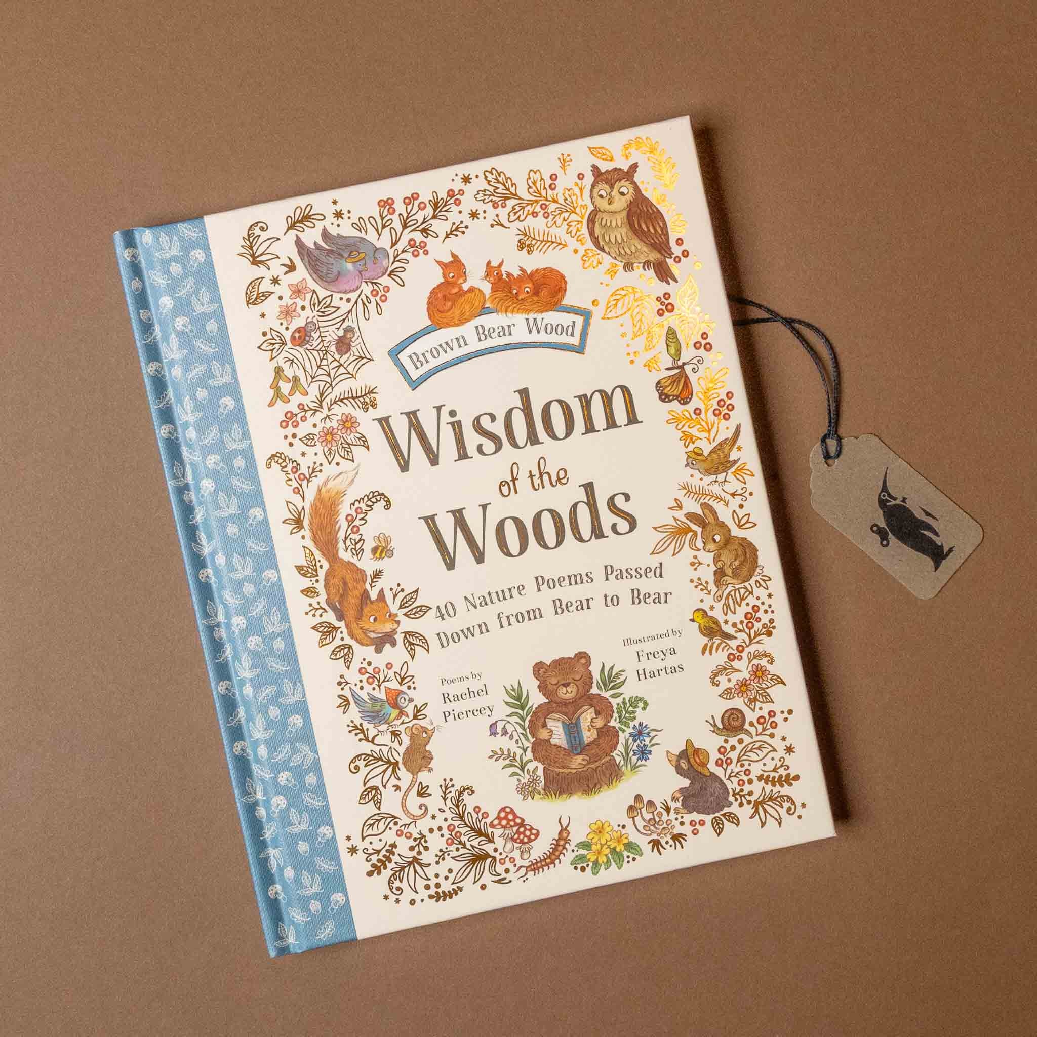 Book titled 'Wisdom of the Woods' with animal illustrations on a brown background