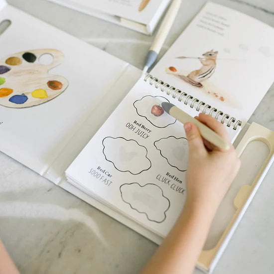 Person coloring a book with a paintbrush on wishy-washy-water-reveal-a-board-book-of-first-words--colors