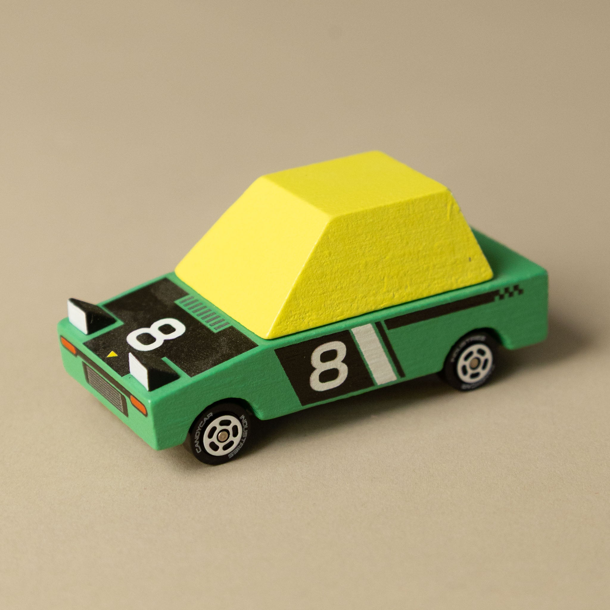 wooden-candycar-toon-4-pack-tokyo-heat Toy car with a yellow roof and green body on a beige background