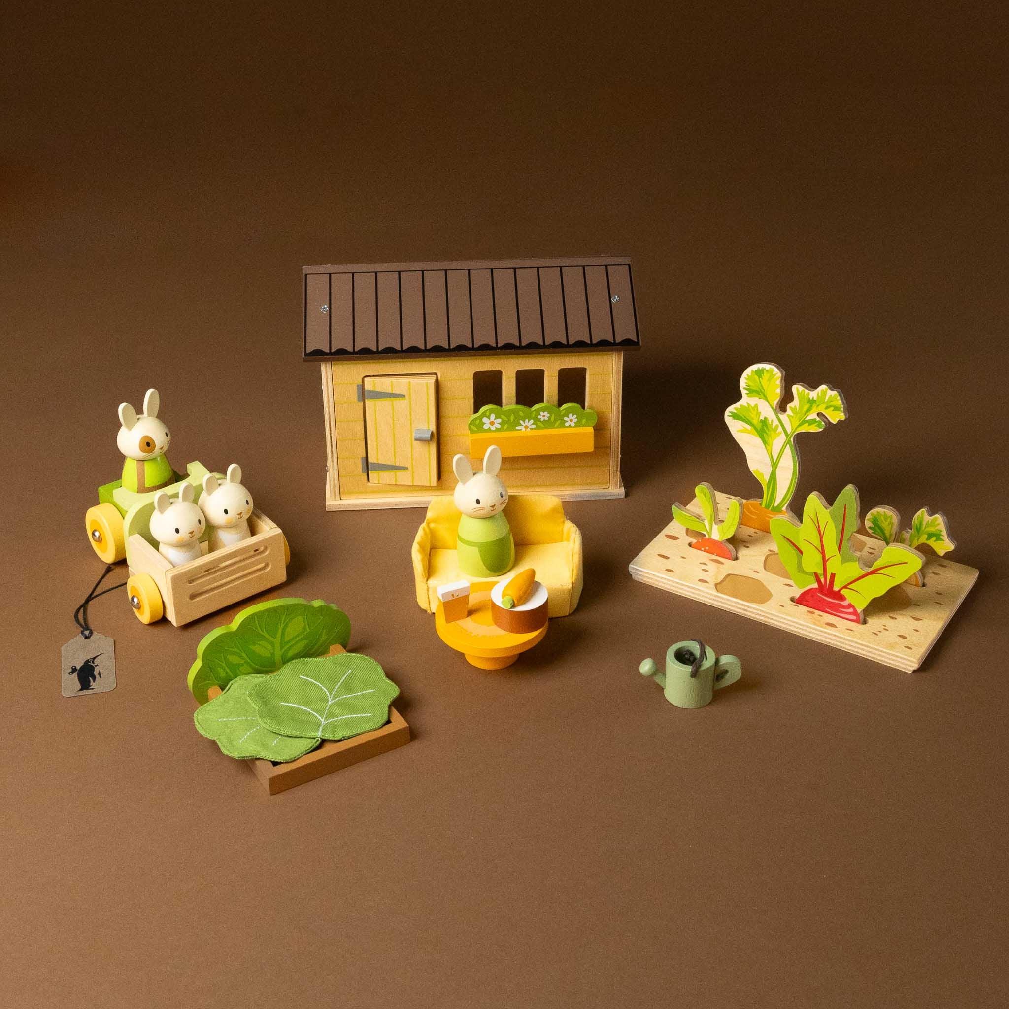 wooden-carrot-patch-play-set with animals and a house on a brown background