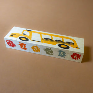 blocks-stacked-to-show-yellow-school-bus-and-colorful-numbers