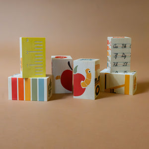stacked-wooden-blocks-with-ruler-animal-numbers-and-handwriting