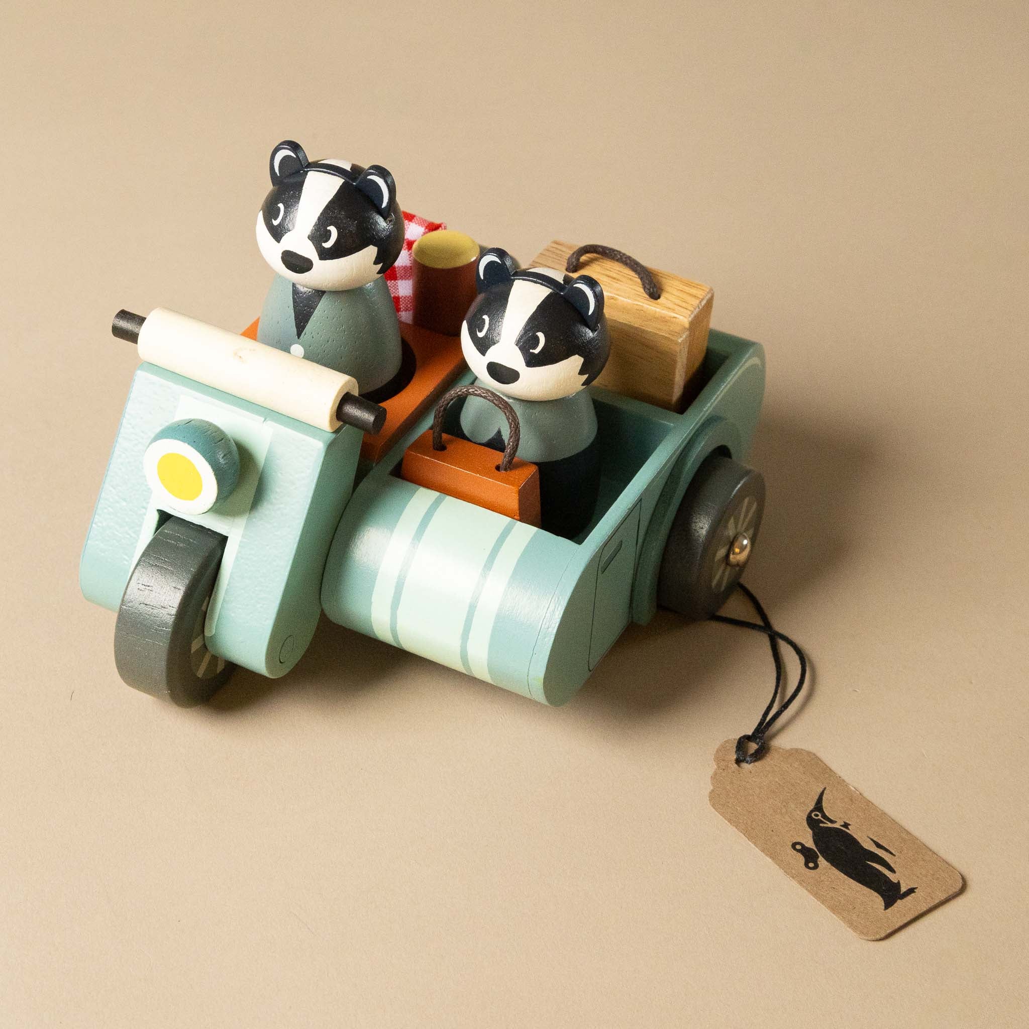wooden-motorbike-picnic-play-set with two badger figures on a beige background