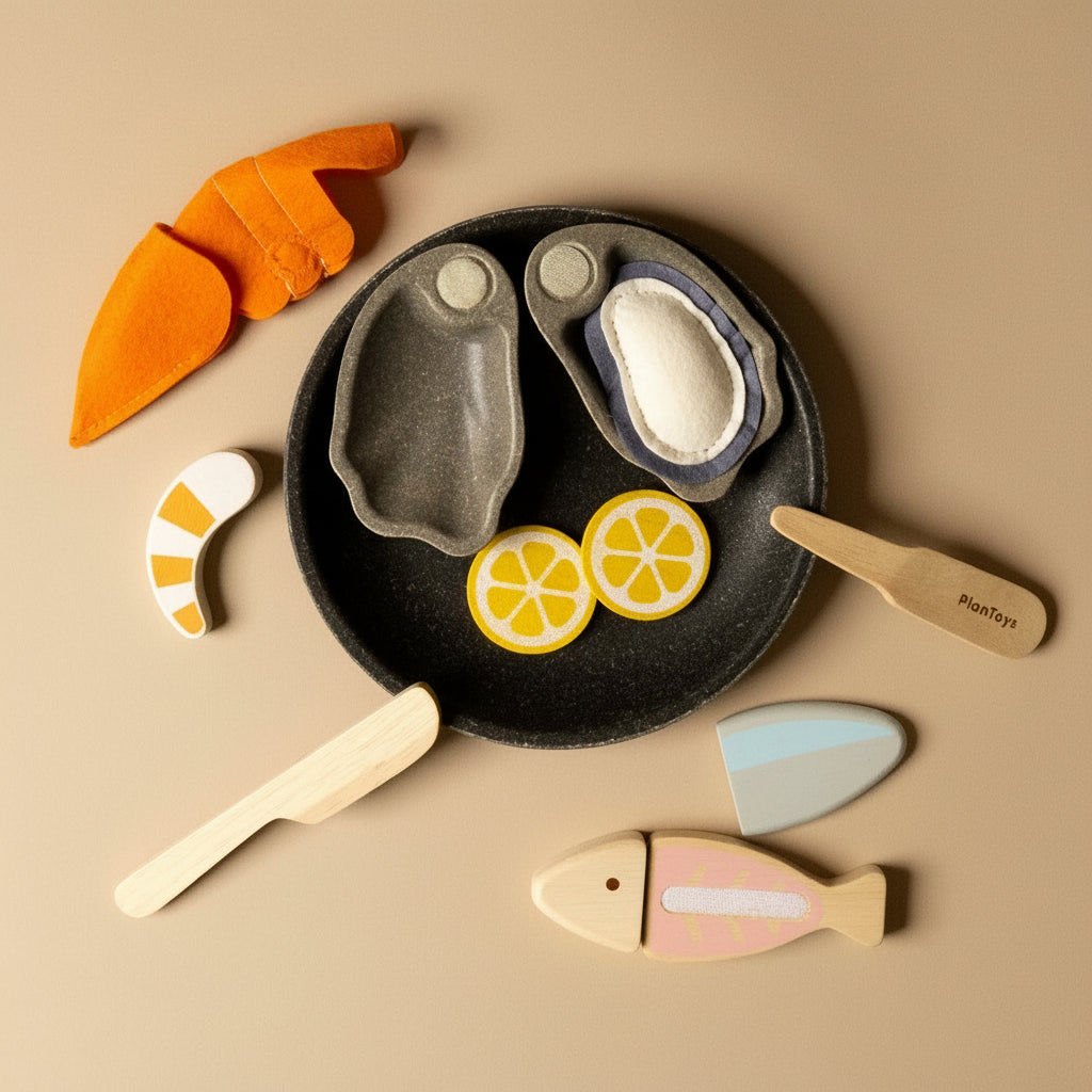 Set of wooden toy food items including a plate with fish, lemon slices, and carrots
