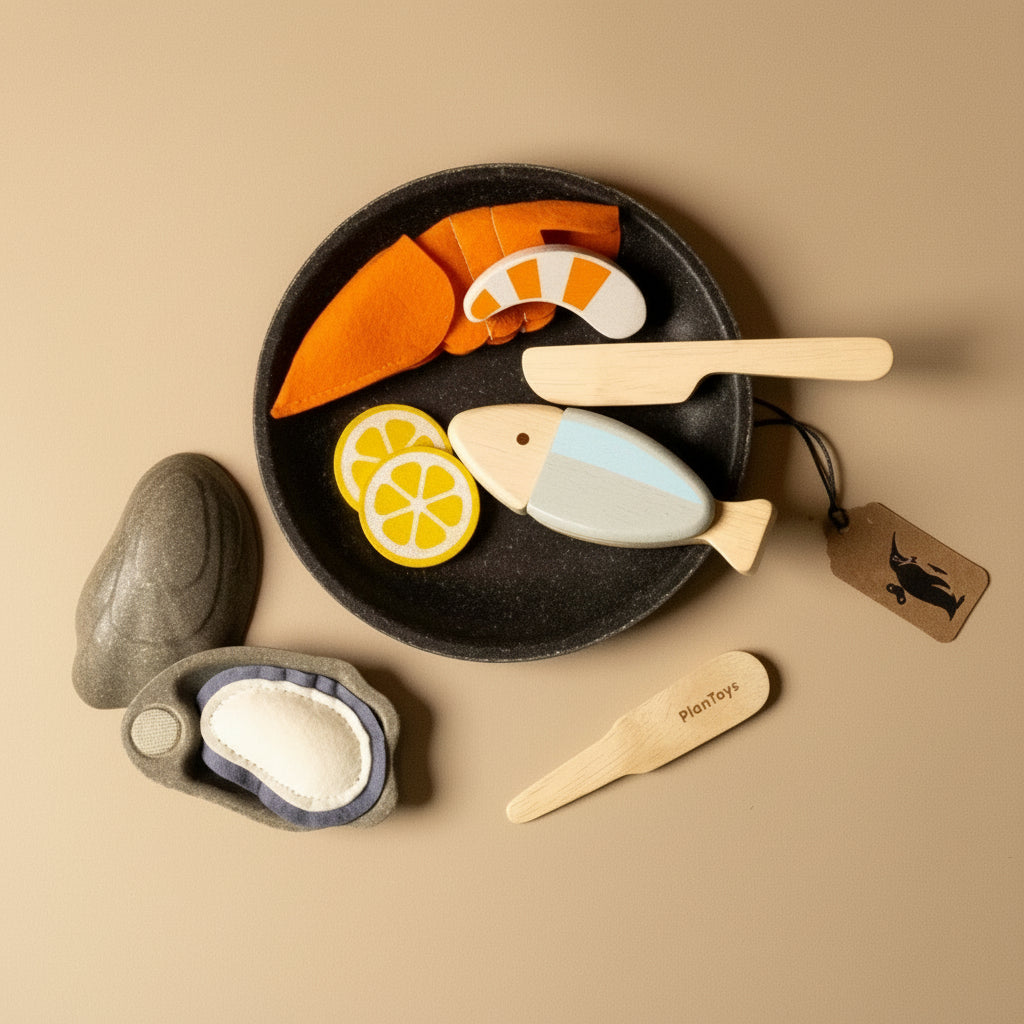 Set of wooden toy food items including a plate with fish, lemon slices, and carrots 