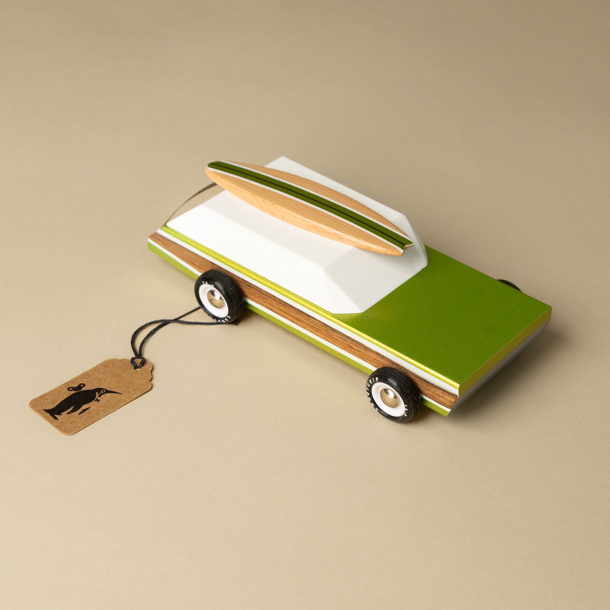 wooden-surf-wagon with a surfboard on top on a beige background