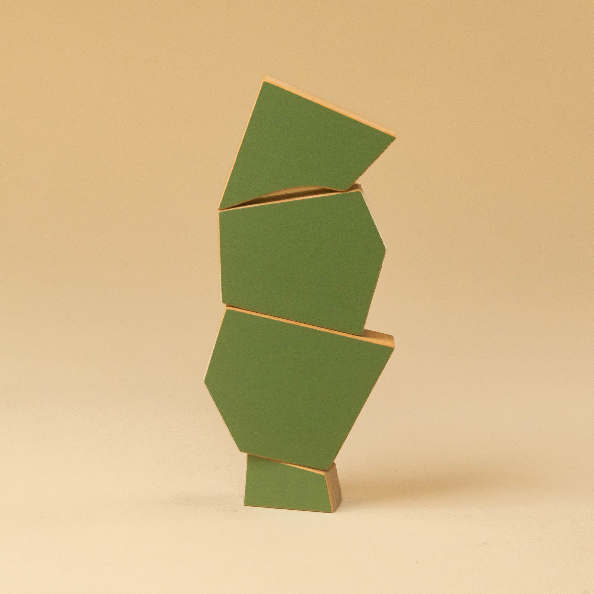 wooden-tree-poplar A minimalist abstract geometric sculpture made of stacked green panels with light wood edges, standing on a beige background.