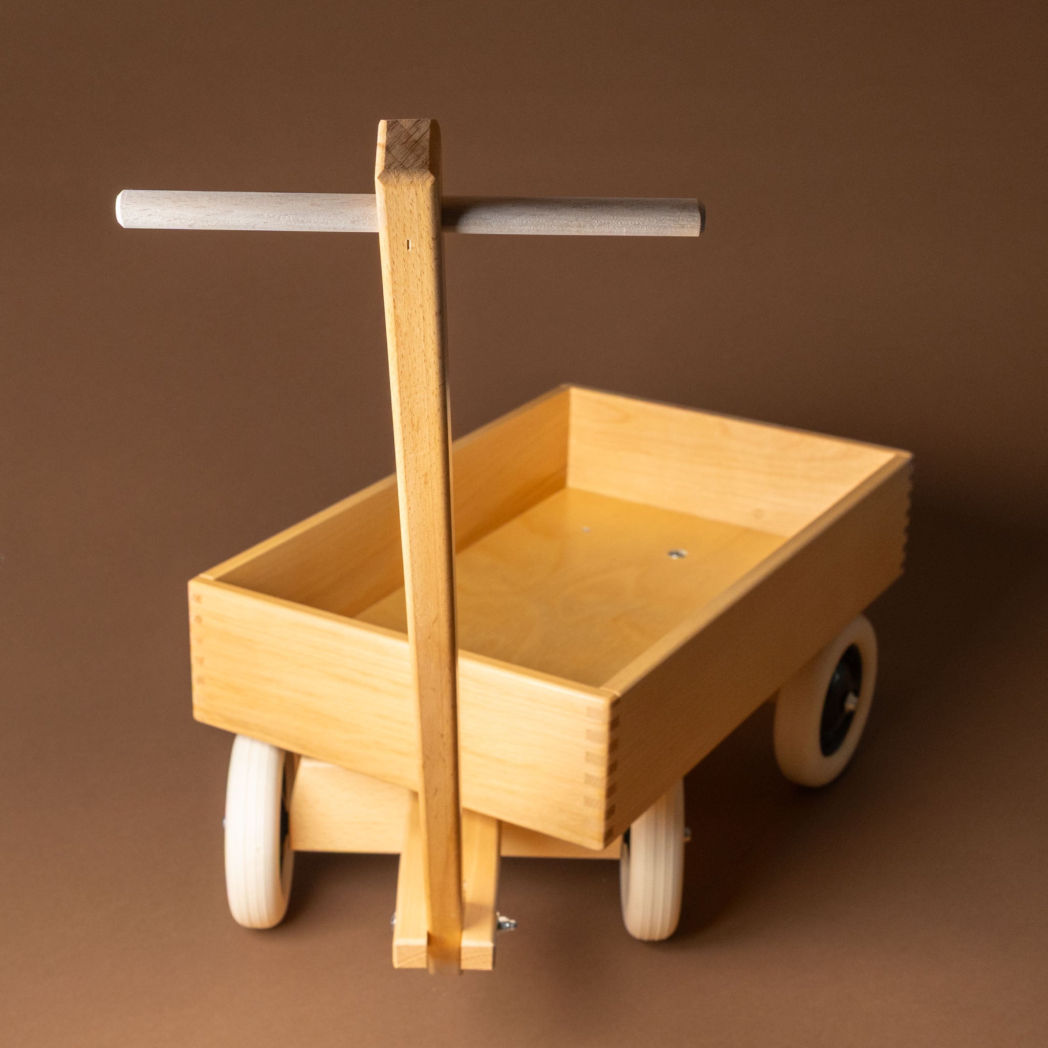 wooden-wagon with a handle on a brown background