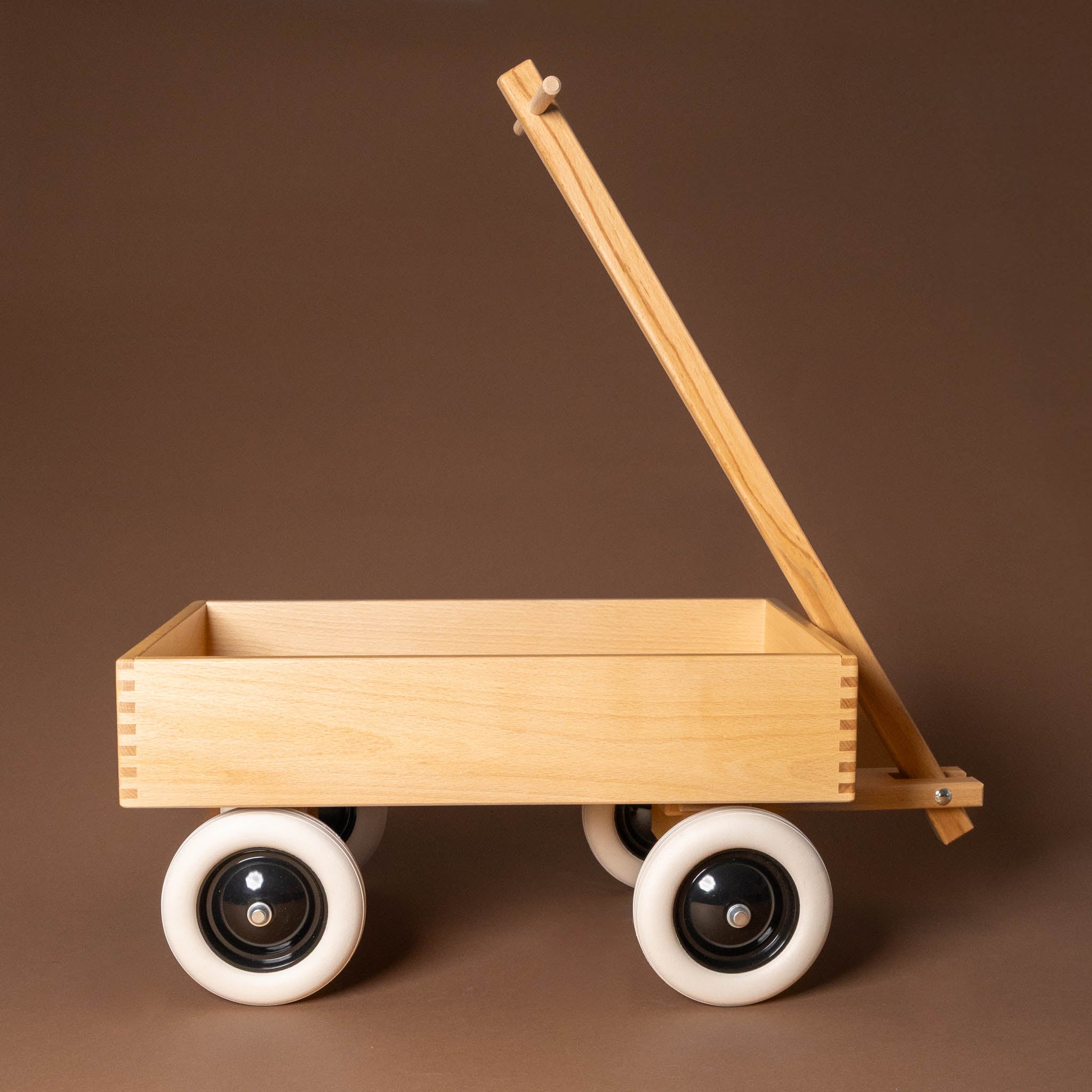 wooden-wagonwith white wheels on a brown background