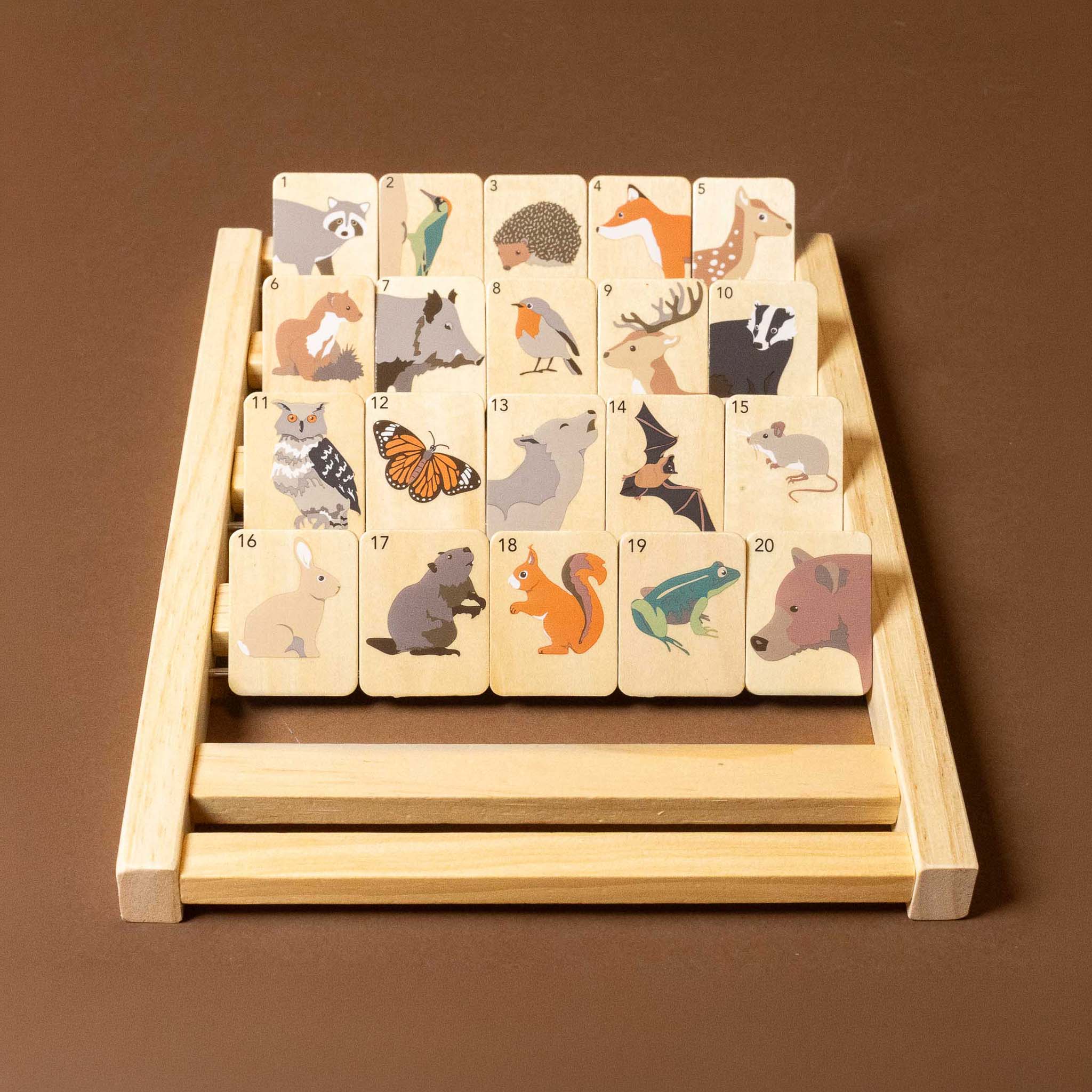 Set of wooden animal wooden-who-am-i-game with a stand on a brown background