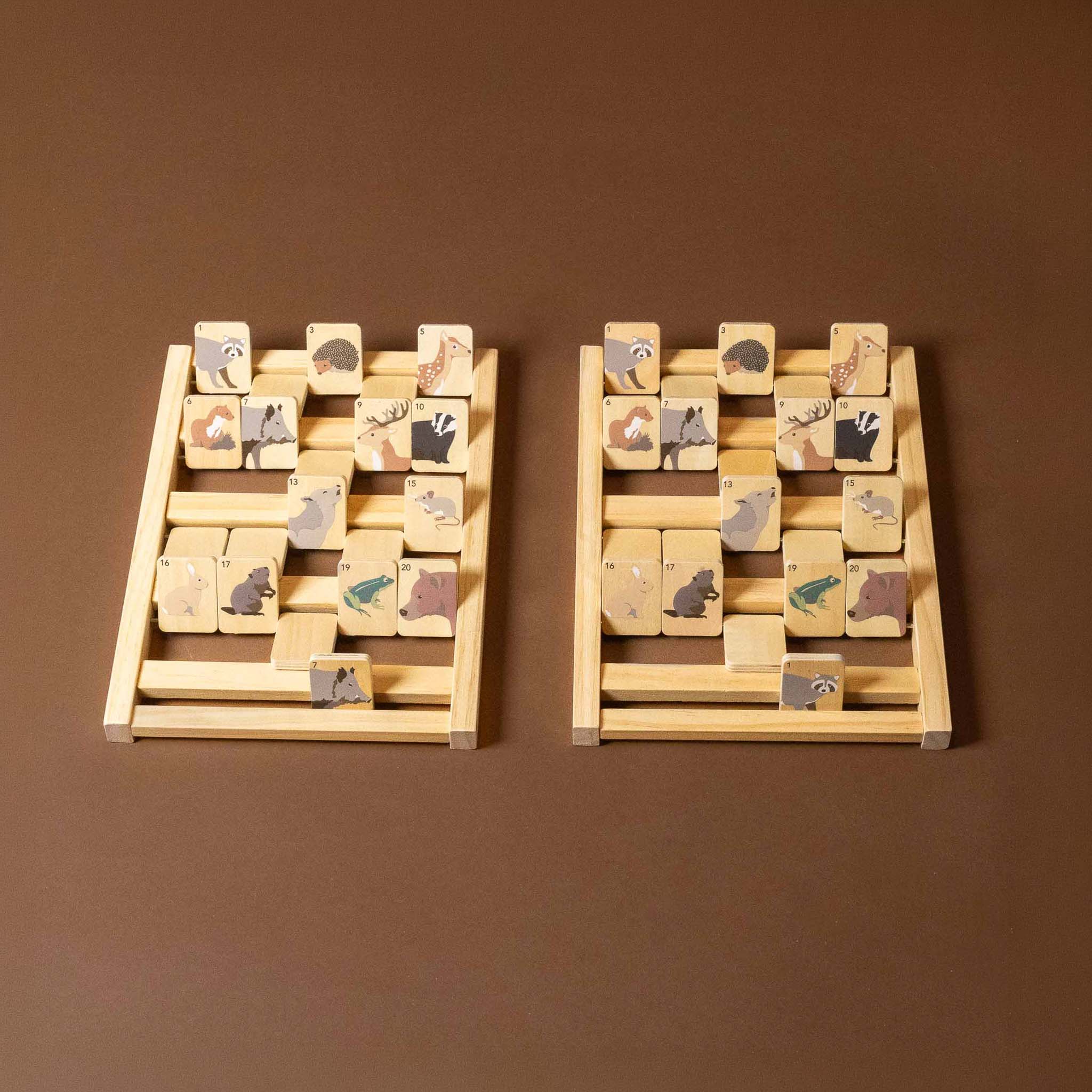 Two wooden wooden-who-am-i-game with animal illustrations on a brown background