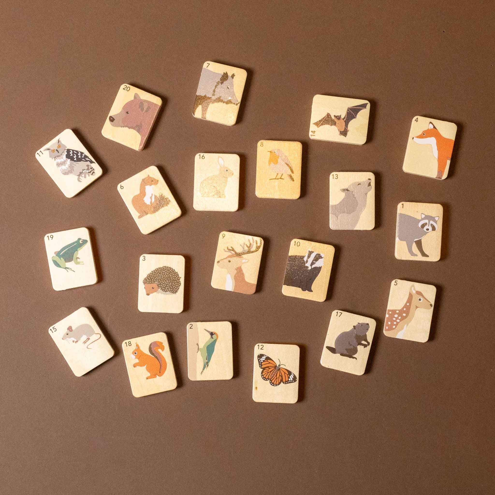 wooden-who-am-i-game Set of wooden animal cards on a brown background