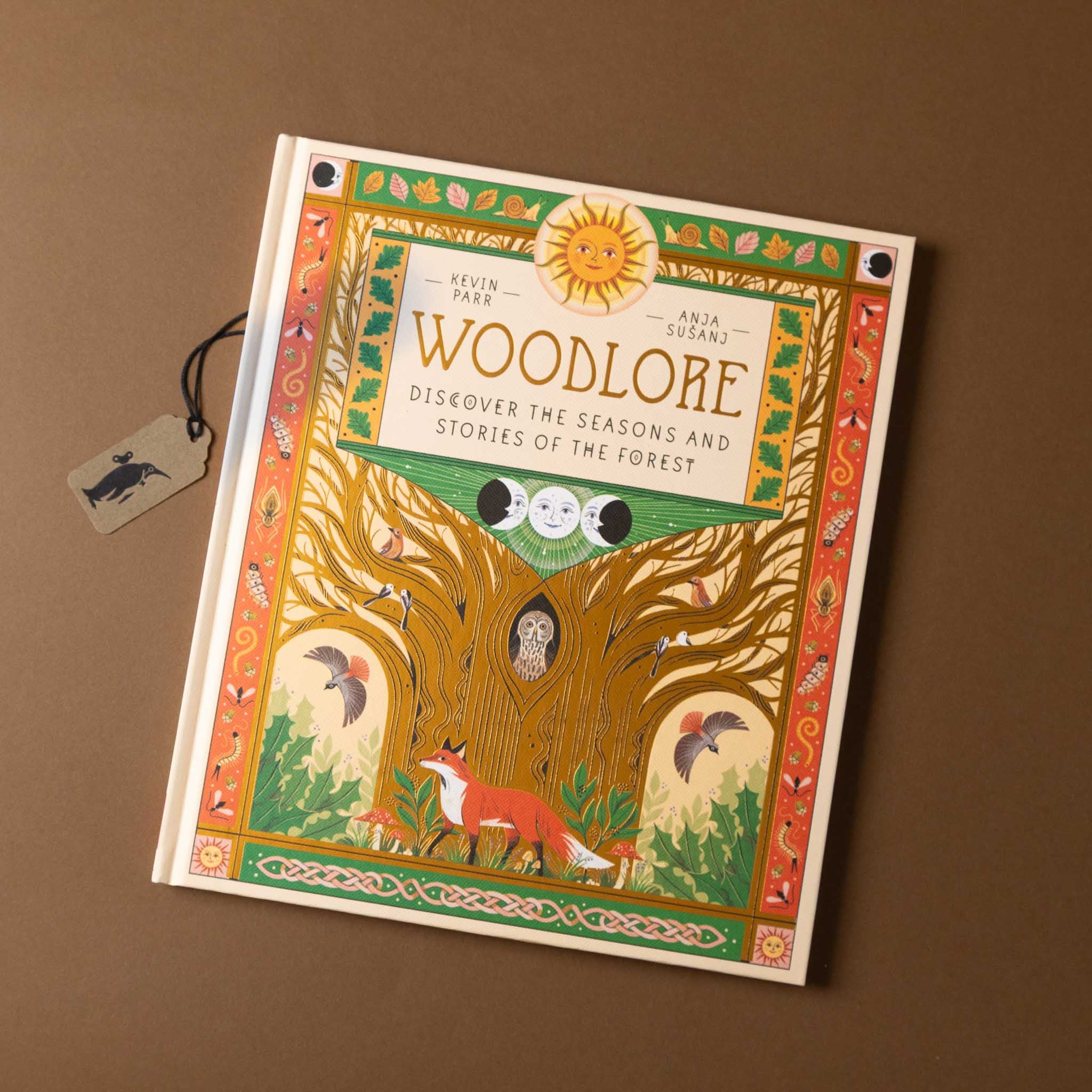 Book titled 'Woodlore' with a forest illustration on a brown background
