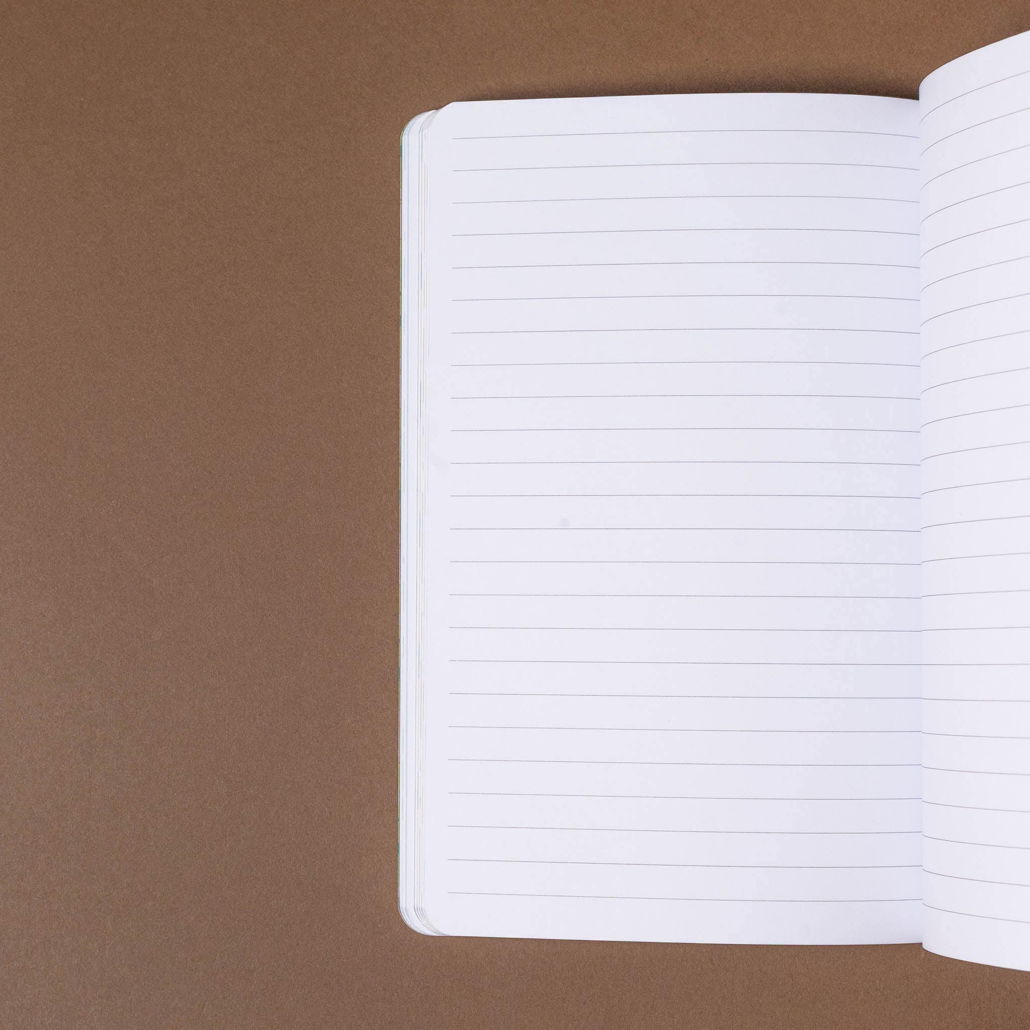 Open notebook with white pages on a brown background