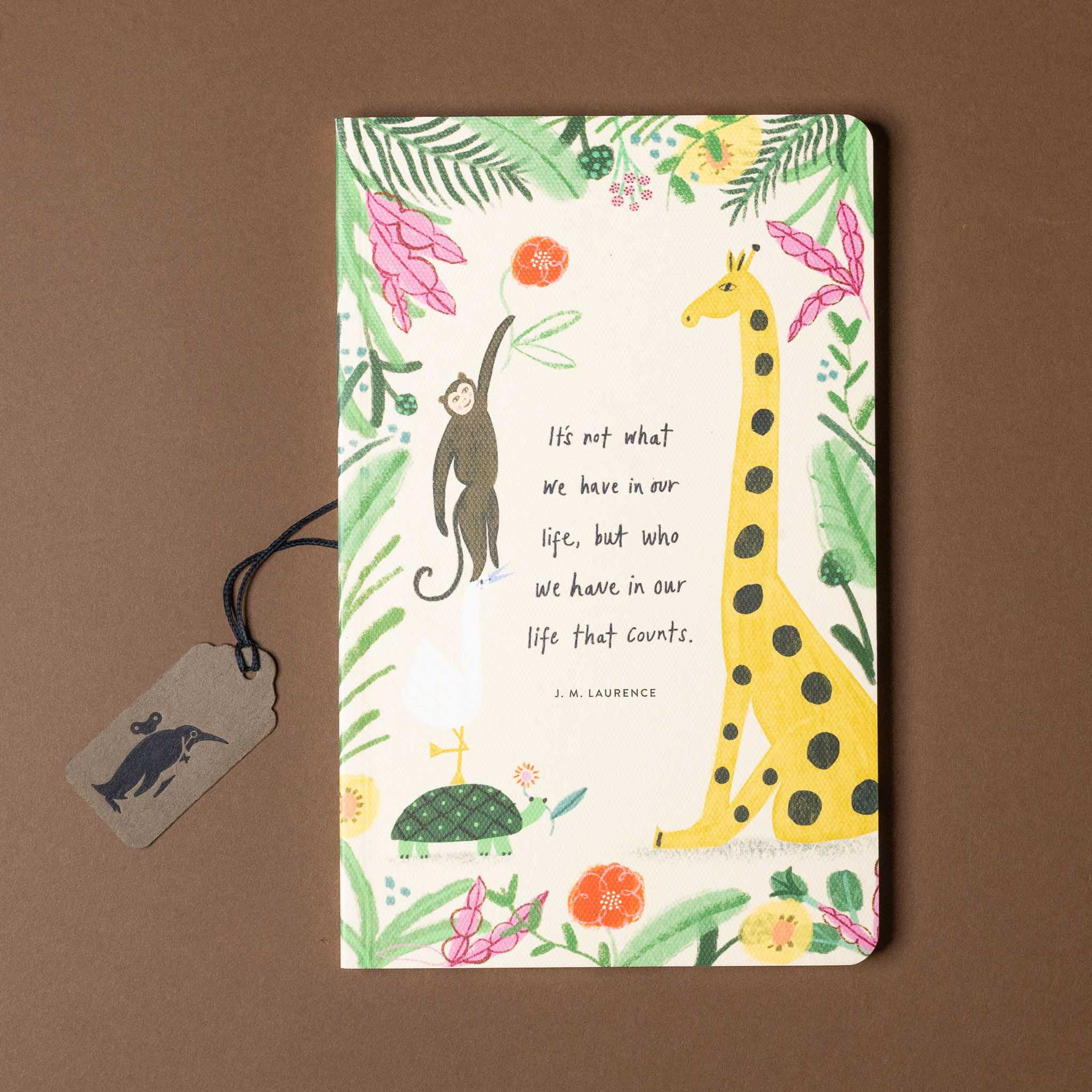 Notebook with animal illustrations and a quote on a brown background