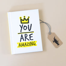 Load image into Gallery viewer, you-are-amazing-book-white-cover-with-black-text-and-yellow-highlighting-of-crown-and-amazing