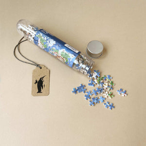 earth-themed-micro-puzzle-in-tube-with-open-lid-and-pieces-spilling-out