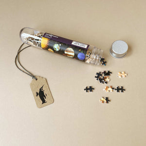 planets-themed-micro-puzzle-in-tube-with-lid-removed-showing-individual-micro-pieces