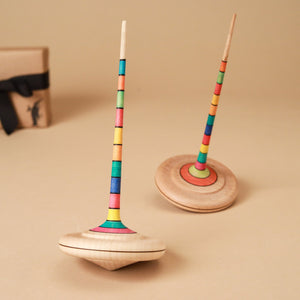 wooden-top-with-long-rainbow-striped-handle